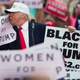 Donald J. Trump kisses a “Women For Trump” sign at a rally in Florida on October 12, 2016 (AP Photo/ Evan Vucci)